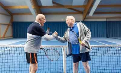 Senior tennis players greeting each other after a game of tennis