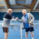 Senior tennis players greeting each other after a game of tennis