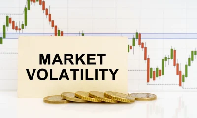 Against the background of the quotes chart, a business card with the inscription - Market Volatility