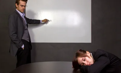 Businesswoman Sleeping in a Conference Room With a Blank Screen