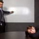 Businesswoman Sleeping in a Conference Room With a Blank Screen