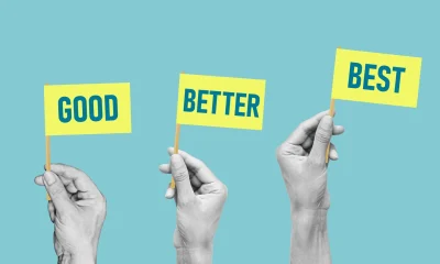 Good, better, best - Hands raise flags with the words. Concept of developing skills, doing a better job and being better