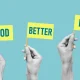 Good, better, best - Hands raise flags with the words. Concept of developing skills, doing a better job and being better