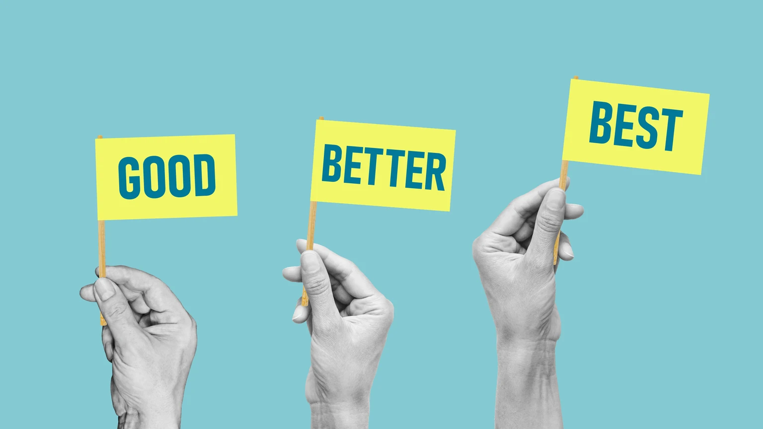 Good, better, best - Hands raise flags with the words. Concept of developing skills, doing a better job and being better