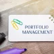 Portfolio management concept. Process of making investment decisions to achieve specific financial goals. business and finance. Inscription on a notepad
