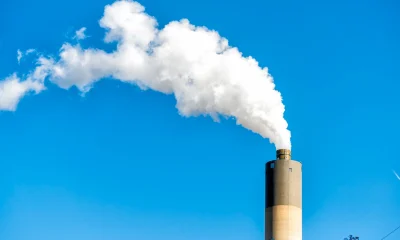 Springfield, Illinois industrial factory smoke from power plant with smoke stack against blue sky