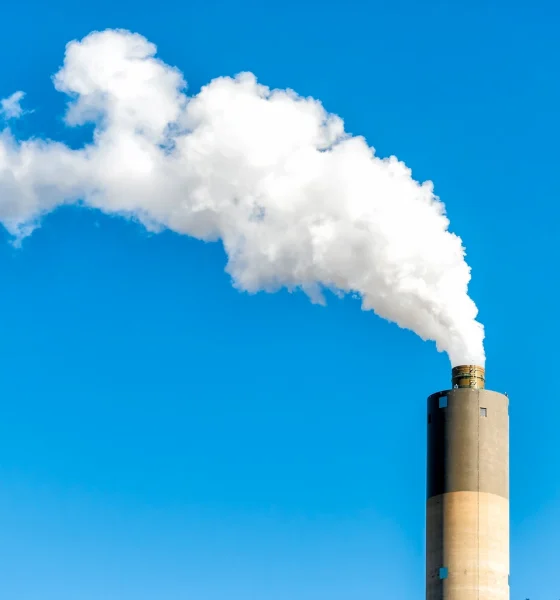 Springfield, Illinois industrial factory smoke from power plant with smoke stack against blue sky