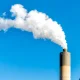 Springfield, Illinois industrial factory smoke from power plant with smoke stack against blue sky