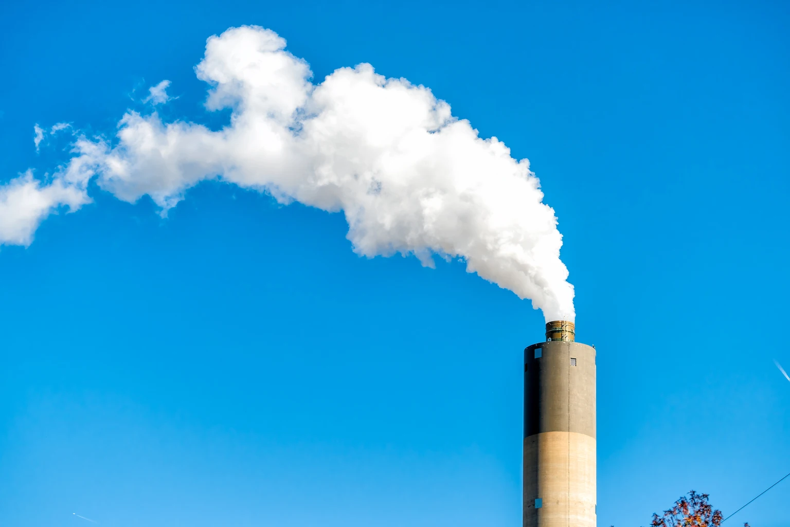 Springfield, Illinois industrial factory smoke from power plant with smoke stack against blue sky