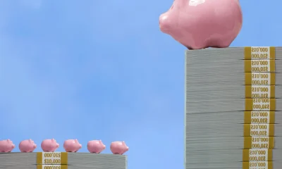 Wealth disparity concept - Large piggy bank over small piggy banks