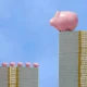 Wealth disparity concept - Large piggy bank over small piggy banks