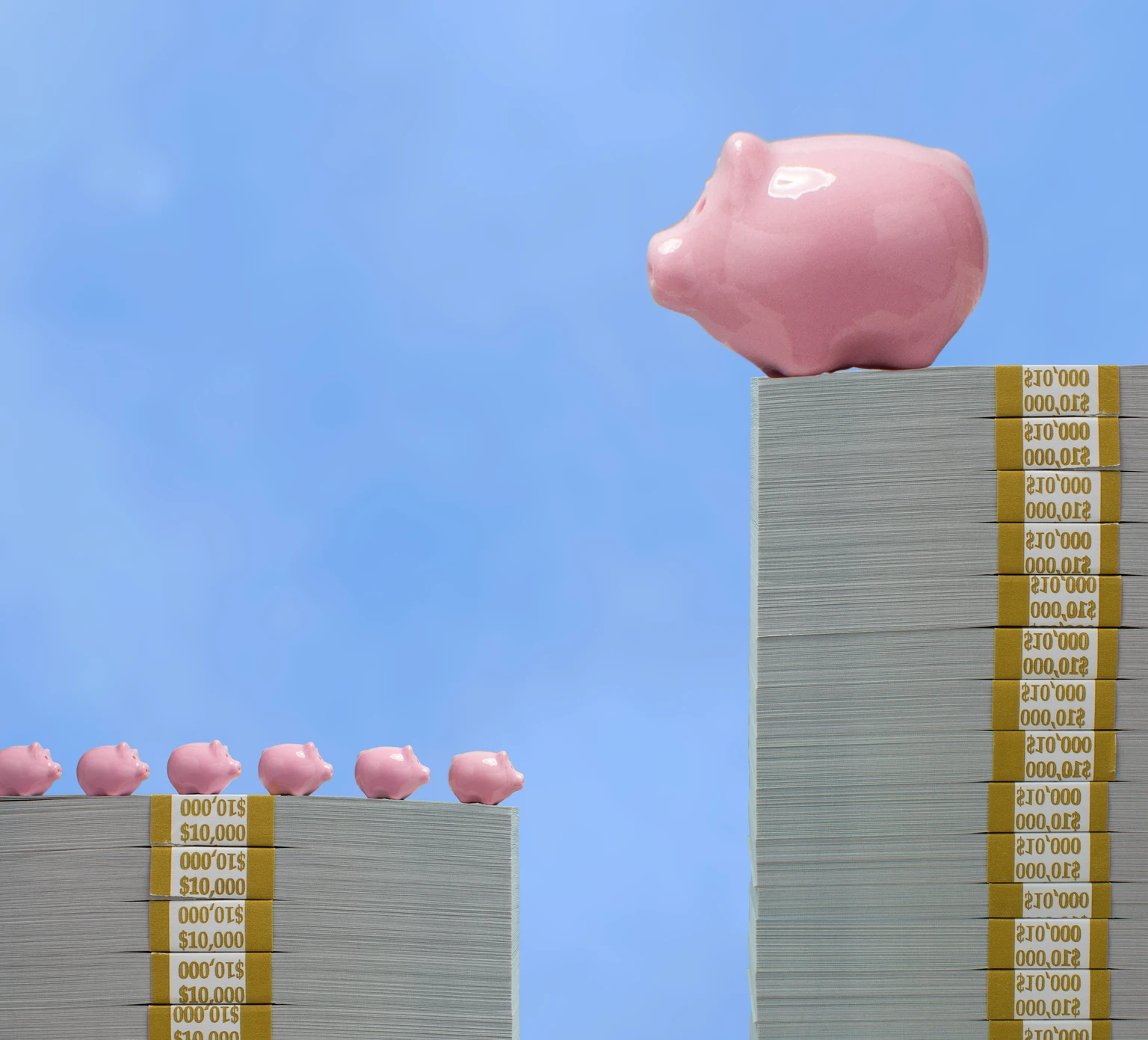 Wealth disparity concept - Large piggy bank over small piggy banks