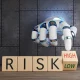 White robotic hand turning a wooden toy block to choose between high and low risk. Illustration of the concept of investment uncertainty, financial analysis and fund ratings