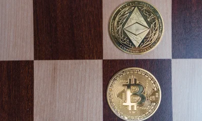 Bitcoin and ethereum classic coins competing on checkerboard