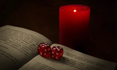 mystical scene with dice, book and candle