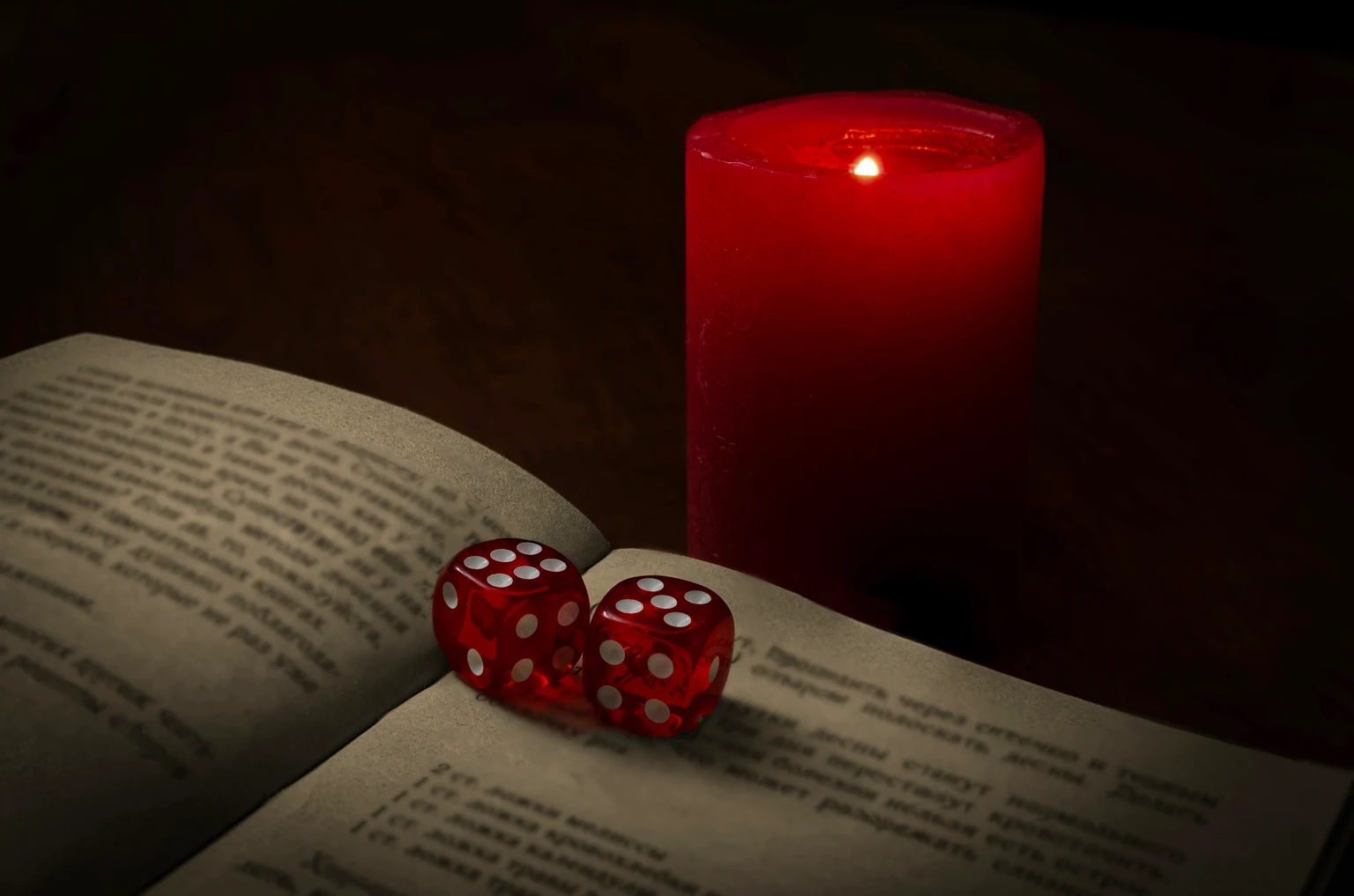 mystical scene with dice, book and candle