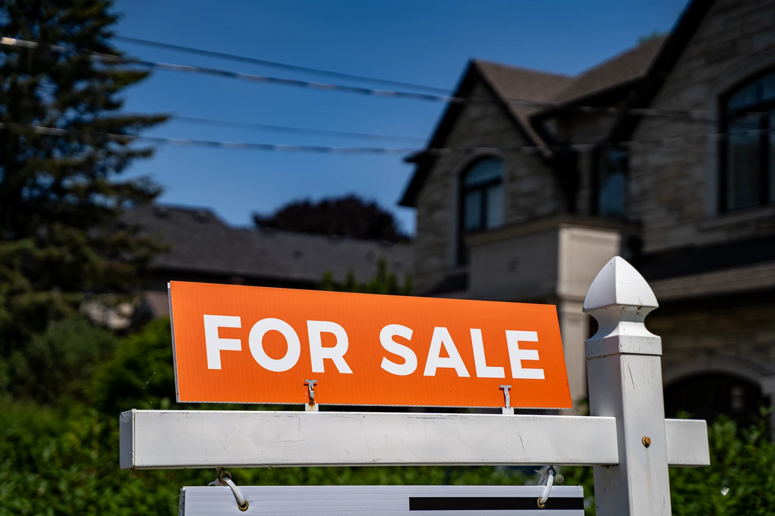 View of for sale sign in front of a house.