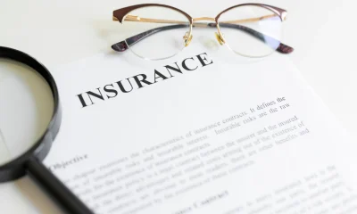 Magnifying glass,eyeglasses and insurance letter