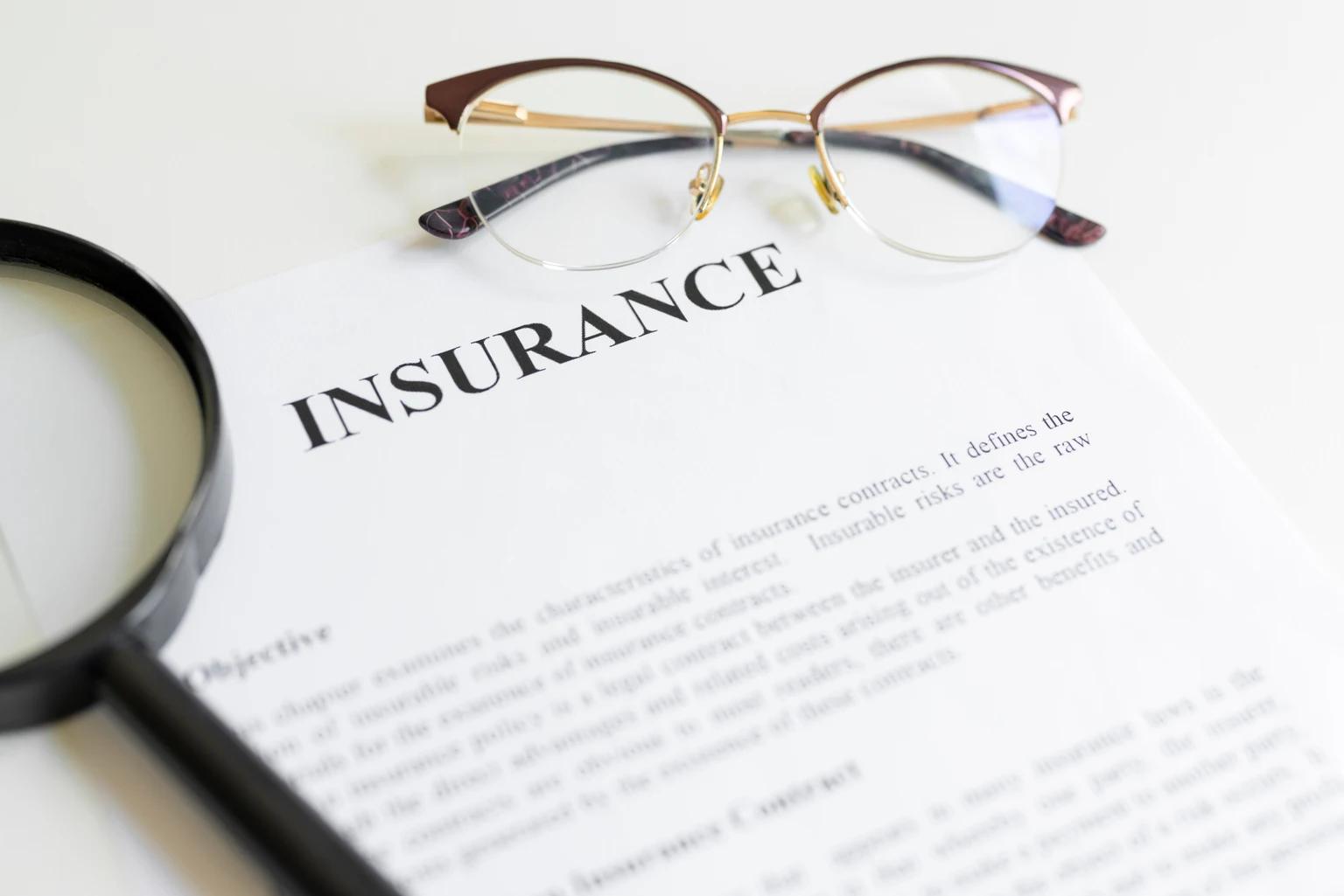 Magnifying glass,eyeglasses and insurance letter