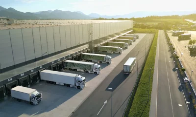 Aerial View Distribution Warehouse with Trucks at Loading Docks