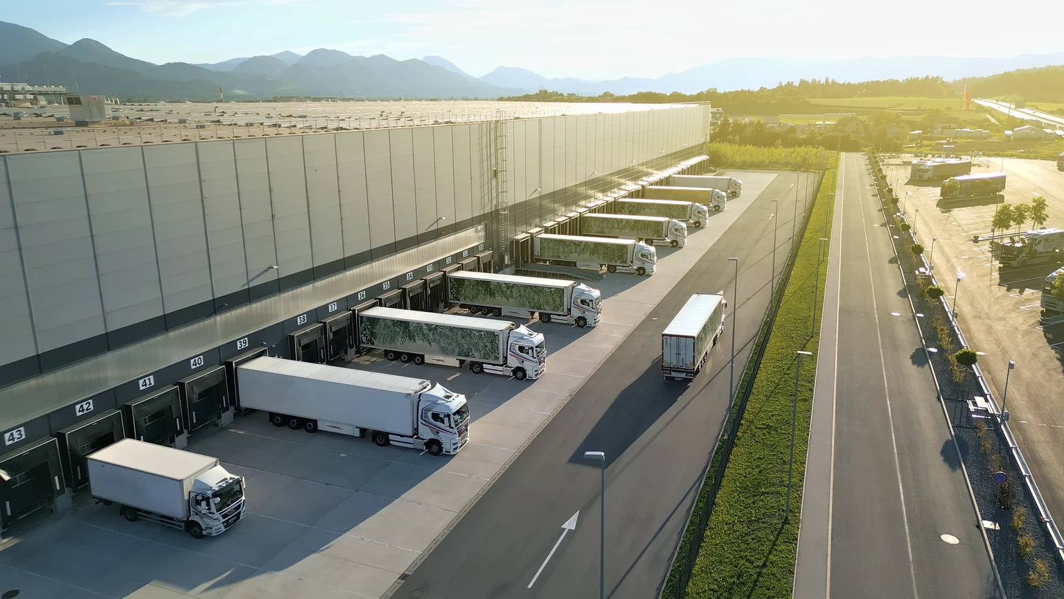 Aerial View Distribution Warehouse with Trucks at Loading Docks