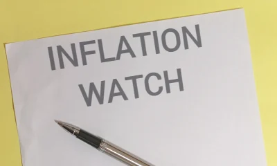 Inflation watch concept with pen on paper