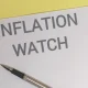 Inflation watch concept with pen on paper
