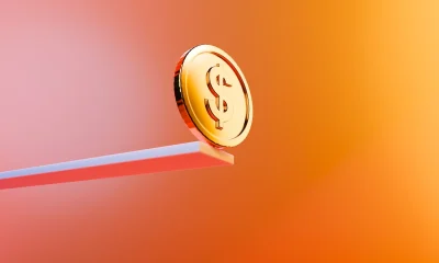 Golden Dollar Coin on Edge - Precarious Financial Trust Concept