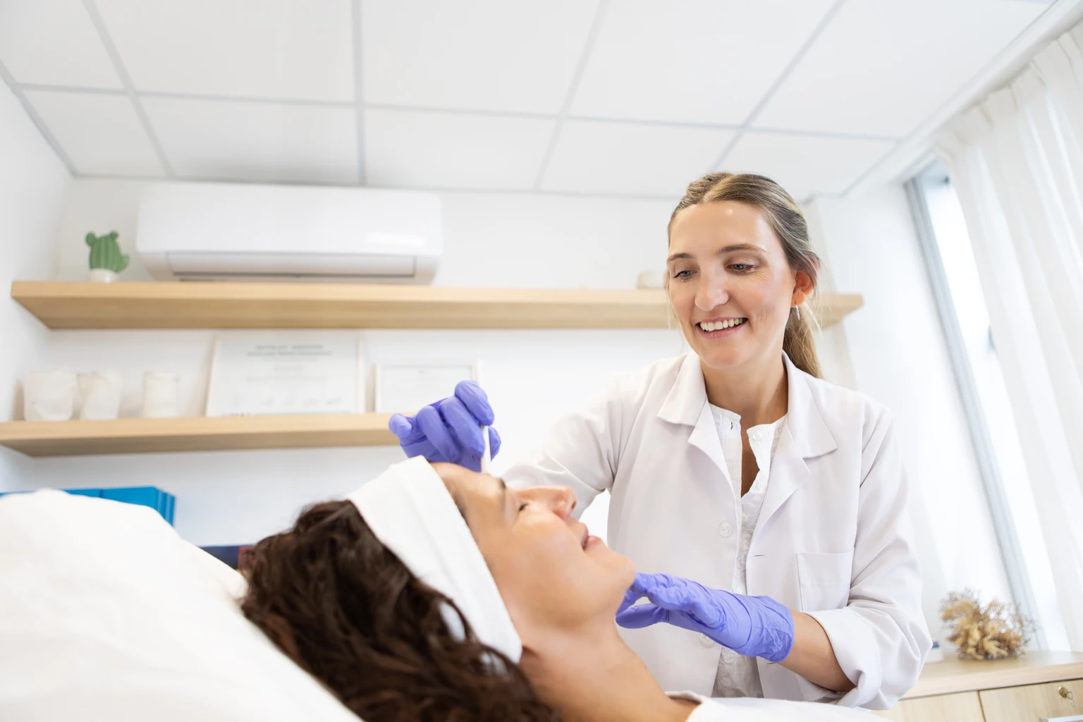 A dermatologist applying a collagen biostimulator to her patient