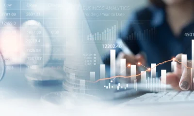 Business, finance and investment concept. Business woman analyzing and calculating financial data with economic graph growth chart, Business strategy and planning. digital market research, financial report