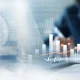 Business, finance and investment concept. Business woman analyzing and calculating financial data with economic graph growth chart, Business strategy and planning. digital market research, financial report