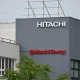 Hitachi and Hitachi Energy Logos on Factory Facade in Industrial Manufacturing Site