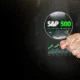 S and P 500 stock market growth shown through magnifying glass and rising growing chart on dark copy space. Financial analysis, investment strategy, trading dashboard, market trend visualization.