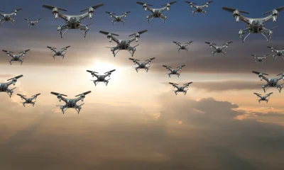 Flock of drones in the sky at sunset