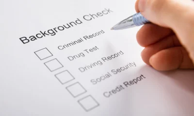 Person Hand Filling Background Check Form