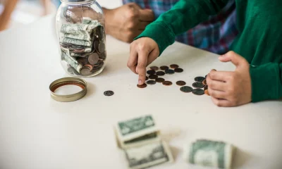 Father and son counting money at home