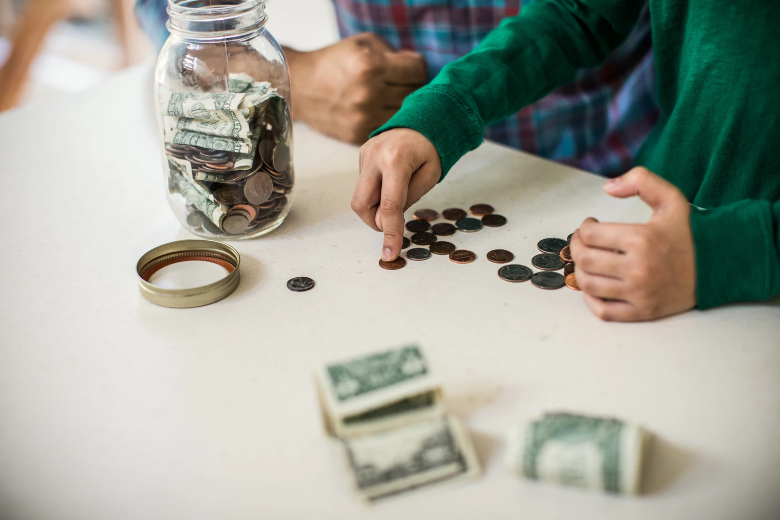 Father and son counting money at home