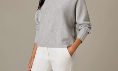woman wears white pants and gray cashmere turtleneck