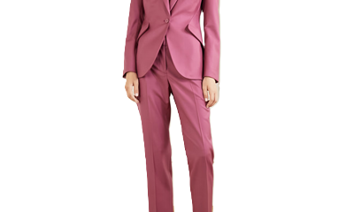 woman wears pink suit; she has super weird shootie mules
