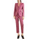 woman wears pink suit; she has super weird shootie mules