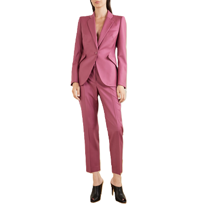 woman wears pink suit; she has super weird shootie mules