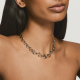 woman wears chunky chain necklace with mixed metals