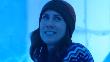 Miriam Shor smiles in a beanie in 'Pluribus'