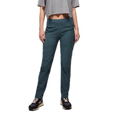 A woman wearing black sneakers, blue pants, and a gray cropped top