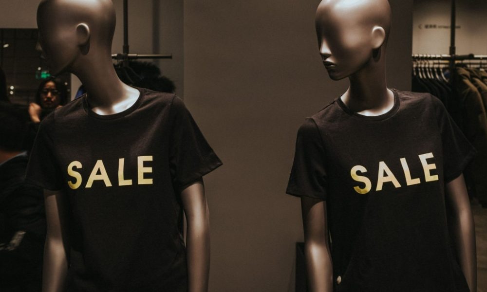 store mannequins wear t-shirts that say SALE