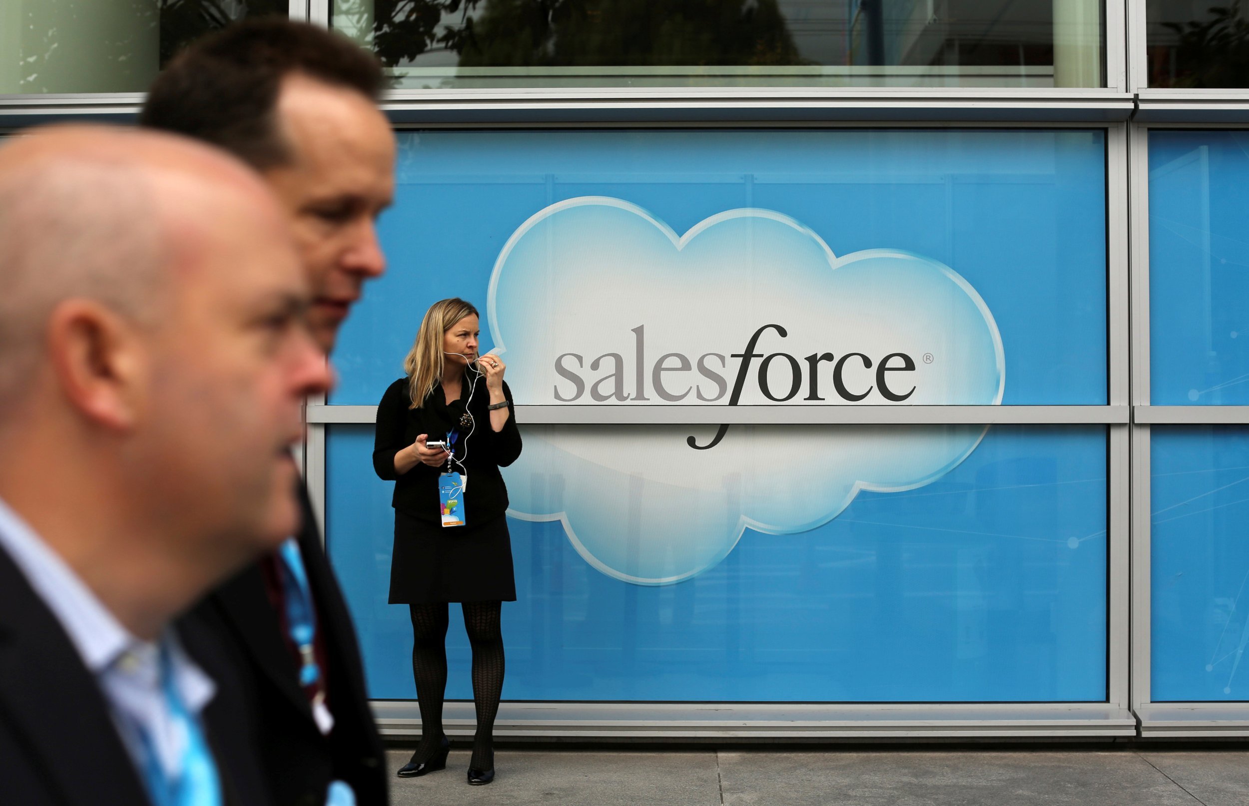 Salesforce has bought word processing startup Quip for $582 million. Here, a woman stands near a Salesforce sign during the company's annual Dreamforce event, in San Francisco, Nov. 18, 2013.