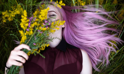 Woman with pink hair dye lying in a