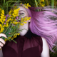 Woman with pink hair dye lying in a