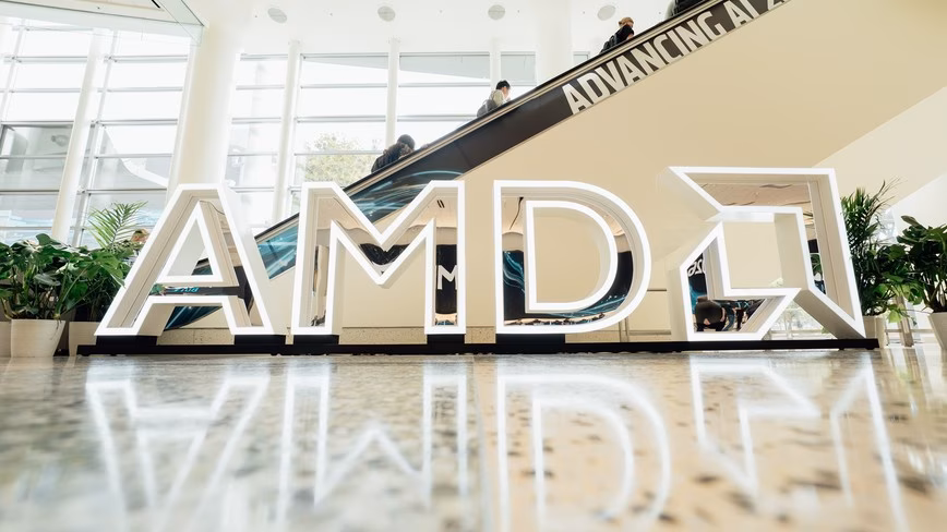 amd illuminated logo sign escalator lobby.avif
