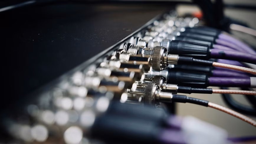 cables plugged into back panel connectors close up.avif